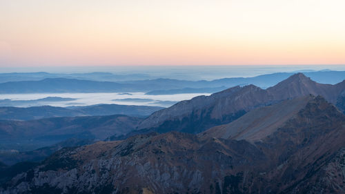 Alpine landscape with mountain ranges, peaks and foggy valley during sunrise, europe, slovakia