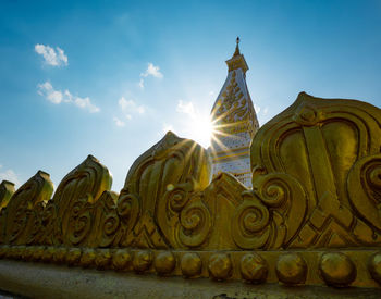 Low angle view of statues on building against sky