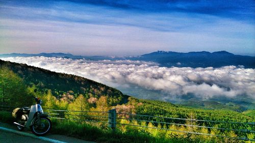 Scenic view of grassy field against cloudy sky