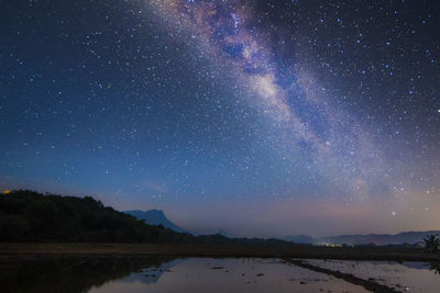 Scenic view of lake against star field at night