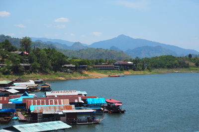 Scenic view of river and mountains against sky