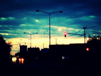 Low angle view of illuminated street light against sky