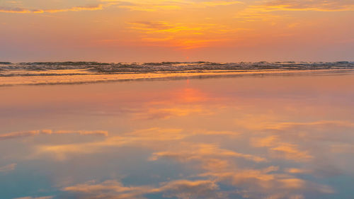 Scenic view of sea against orange sky