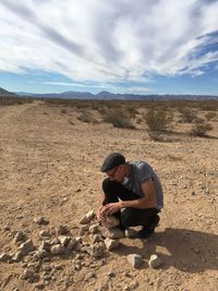 Full length of man crouching on land