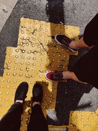 Low section of people standing on road