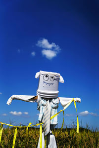 Traditional windmill on field against sky