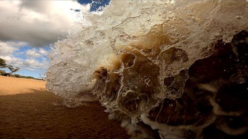 Close-up of wave splashing on beach