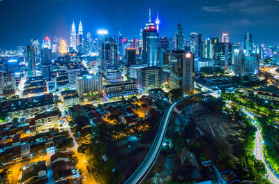 High angle view of city lit up at night