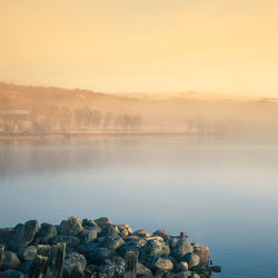 Scenic view of lake against sky during sunset