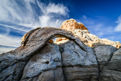 Low angle view of rock formation against sky