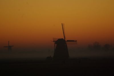 Silhouette of windmill against sky during sunset