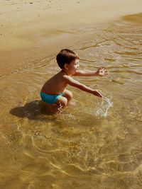 High angle view of boy playing in water