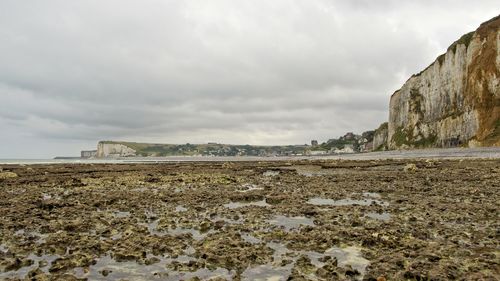Surface level of beach against sky