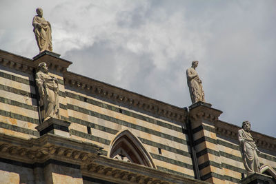 Low angle view of statue against cloudy sky