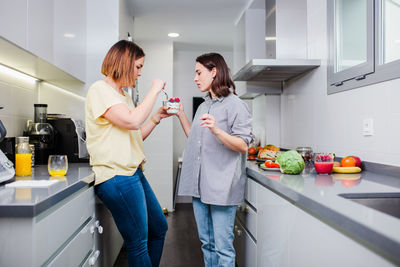 Women preparing food at kitchen