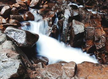 View of waterfall along rocks