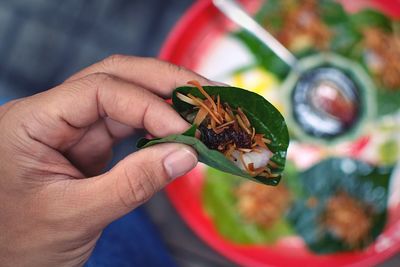 Cropped hand holding snack