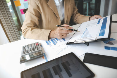 Midsection of business colleagues working in office