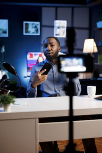 Young woman using mobile phone in office