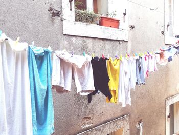 Clothes drying on clothesline against wall