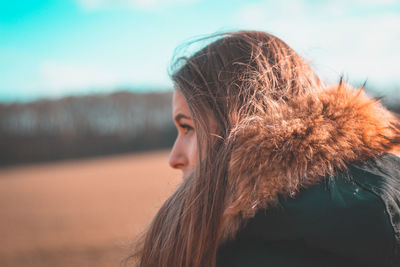 Close-up of beautiful young woman against sky