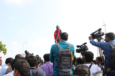 Rear view of people looking at sky