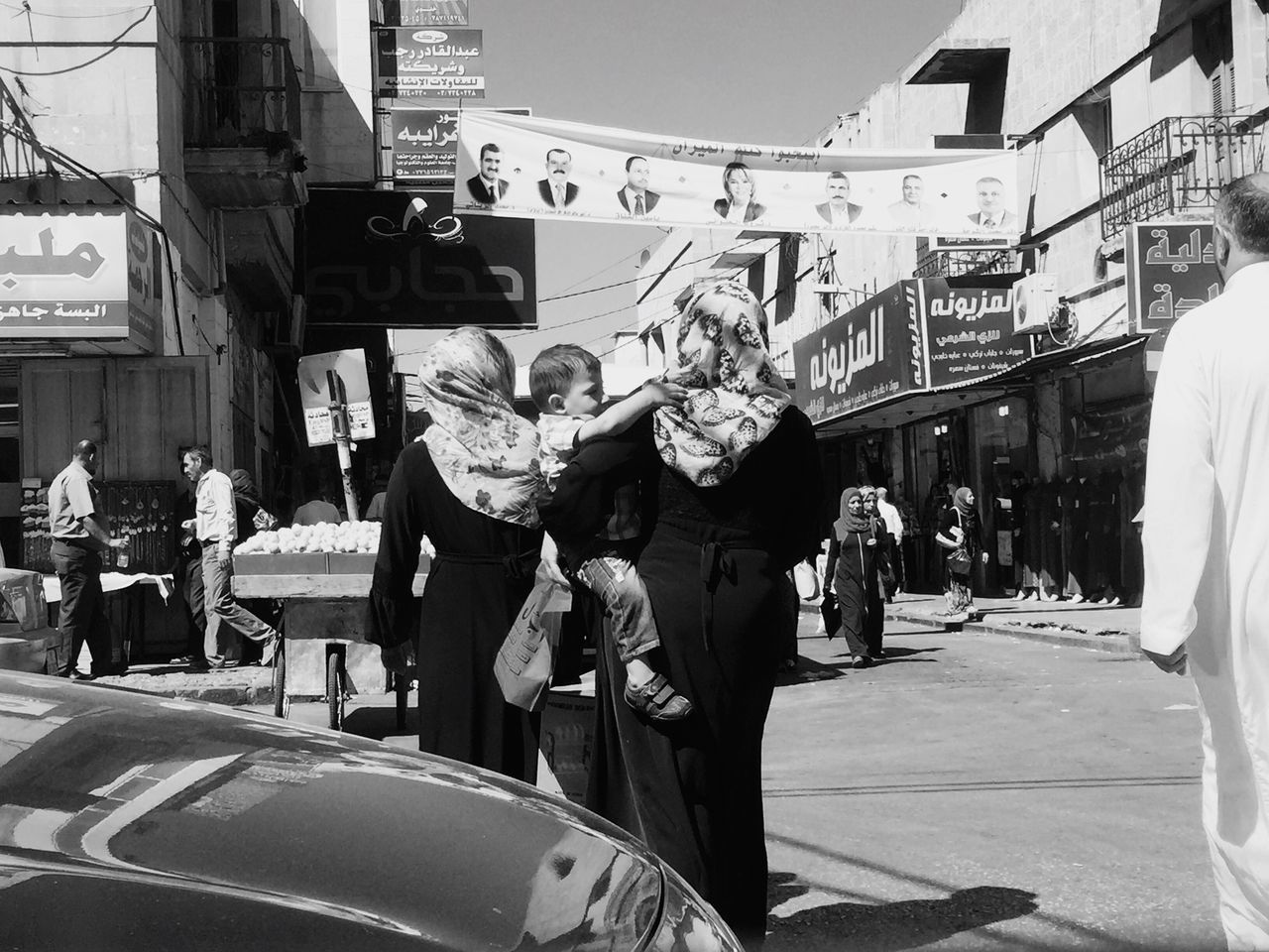 architecture, building exterior, built structure, street, city, large group of people, men, road, city life, person, walking, transportation, group of people, narrow, day, outdoors, crowd, long, the way forward