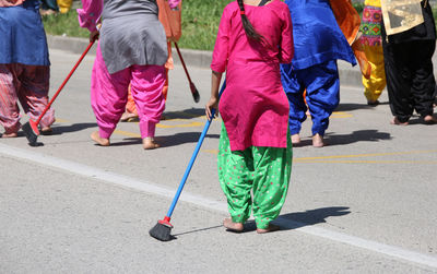 Low section of people walking on road