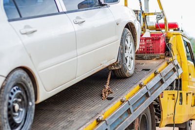 Close-up of damaged car towing outdoors