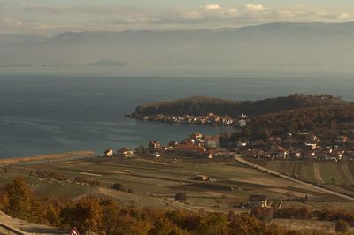 Scenic view of sea and mountains against sky