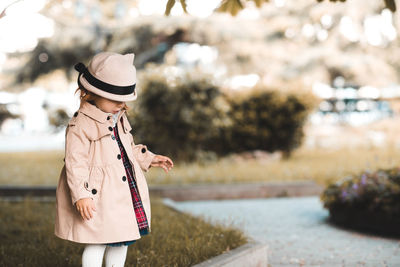 Full length of girl wearing hat standing at park