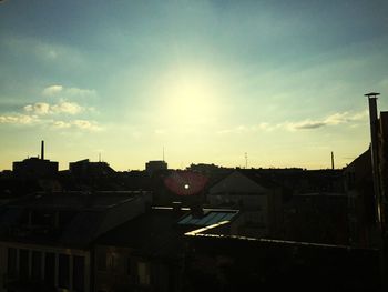 Buildings against sky at sunset