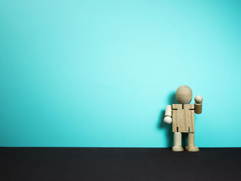 Toy on table against blue background