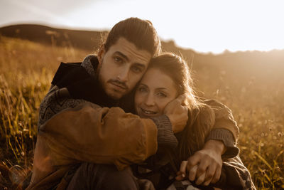 Portrait of couple kissing on field