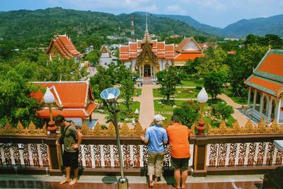 People at temple outside building