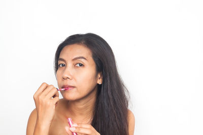 Portrait of beautiful woman against white background