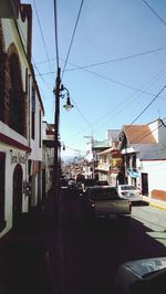 Cars on road along buildings