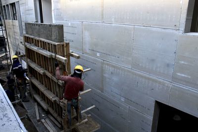 People working at construction site in city