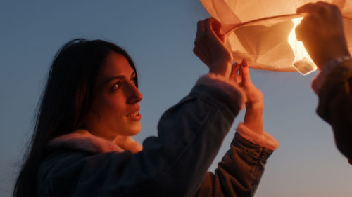 Boy and girl couple are preparing the chinese lantern