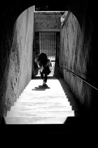 Rear view of woman moving down on staircase