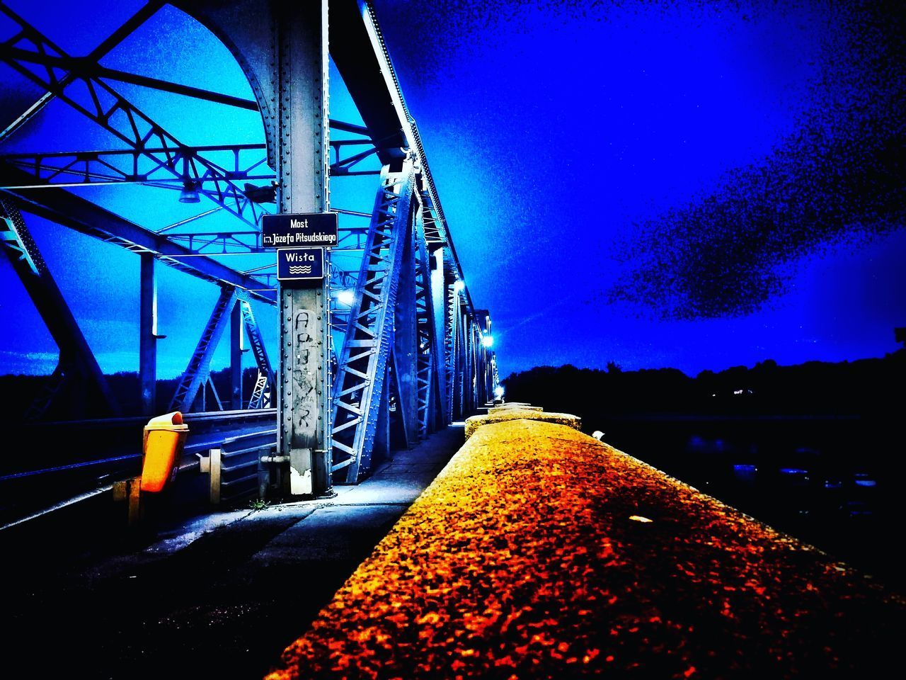 BRIDGE OVER RIVER AGAINST BLUE SKY
