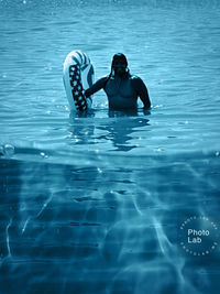 Portrait of shirtless man in swimming pool