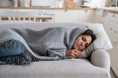 Young woman sleeping on bed at home