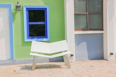 Empty chair outside building