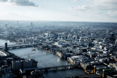 High angle view of cityscape against cloudy sky