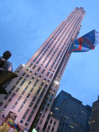 Low angle view of flags against buildings in city