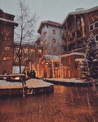 Illuminated building in city during winter