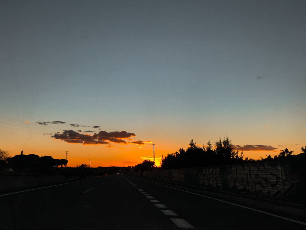 SILHOUETTE ROAD AGAINST SKY DURING SUNSET