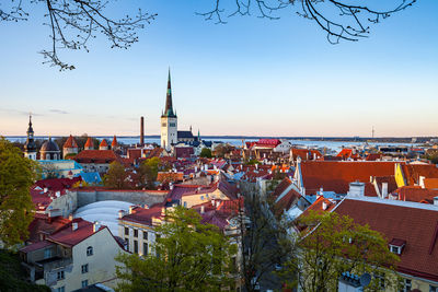 High angle view of town by sea against sky