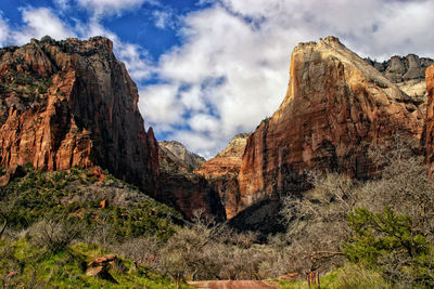 Rock formations on landscape against cloudy sky